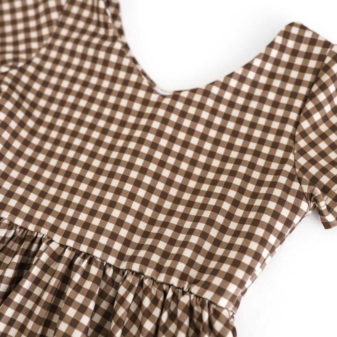 closeup of two-tone brown gingham twirl dress print on fall v-neck twirl dress