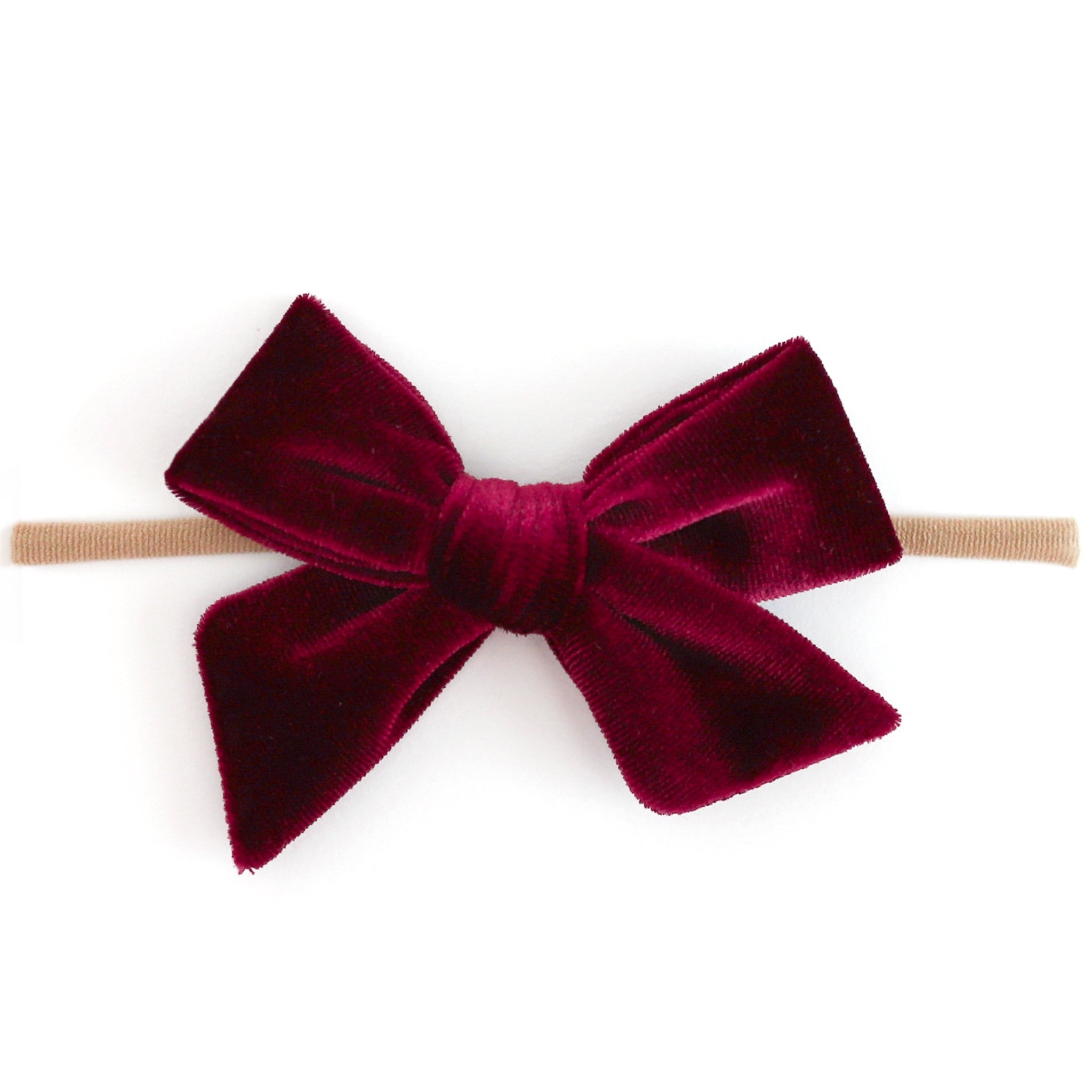 A deep burgundy velvet bow headband on a clean white background.