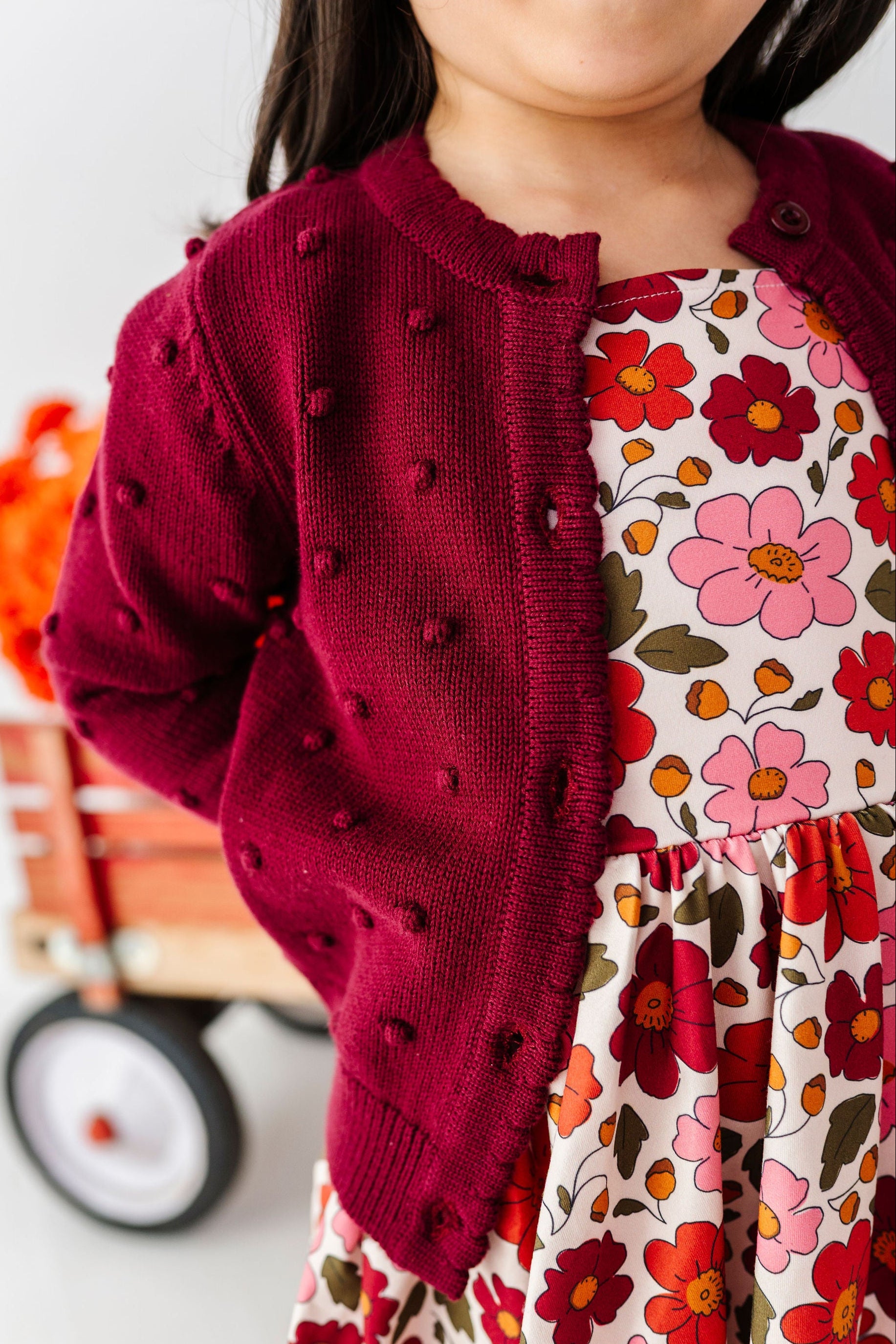 detail of burgundy bobble knit cotton sweater for girls