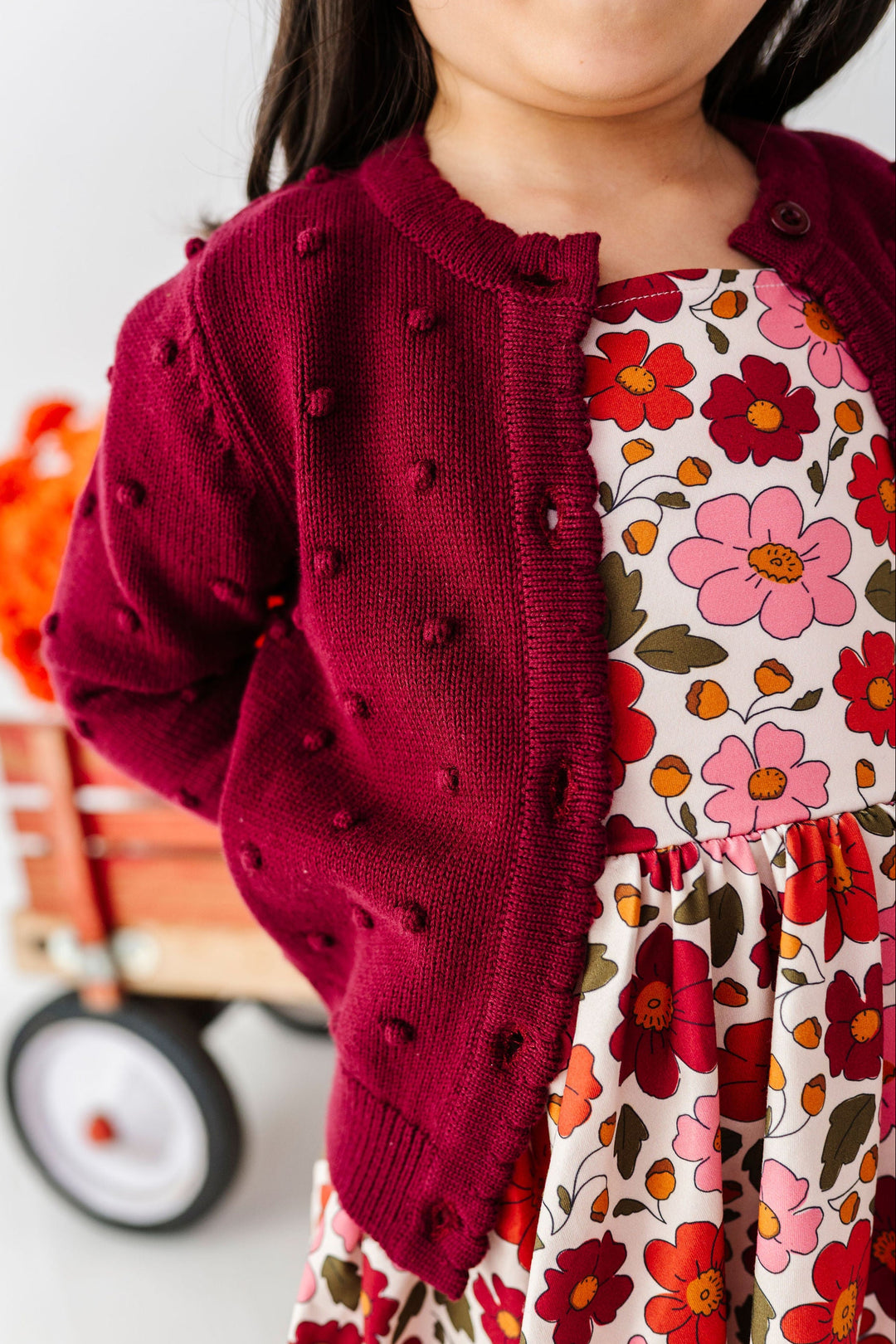 detail of burgundy bobble knit cotton sweater for girls