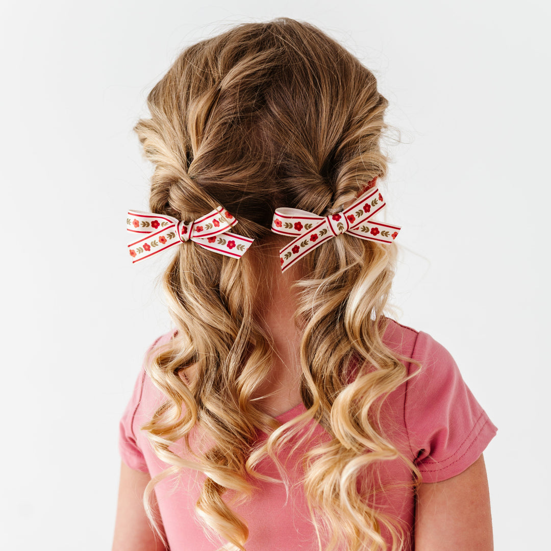 little girl with pigtails in old rose twirl dress and burgundy floral print ribbon pigtail bows on clips