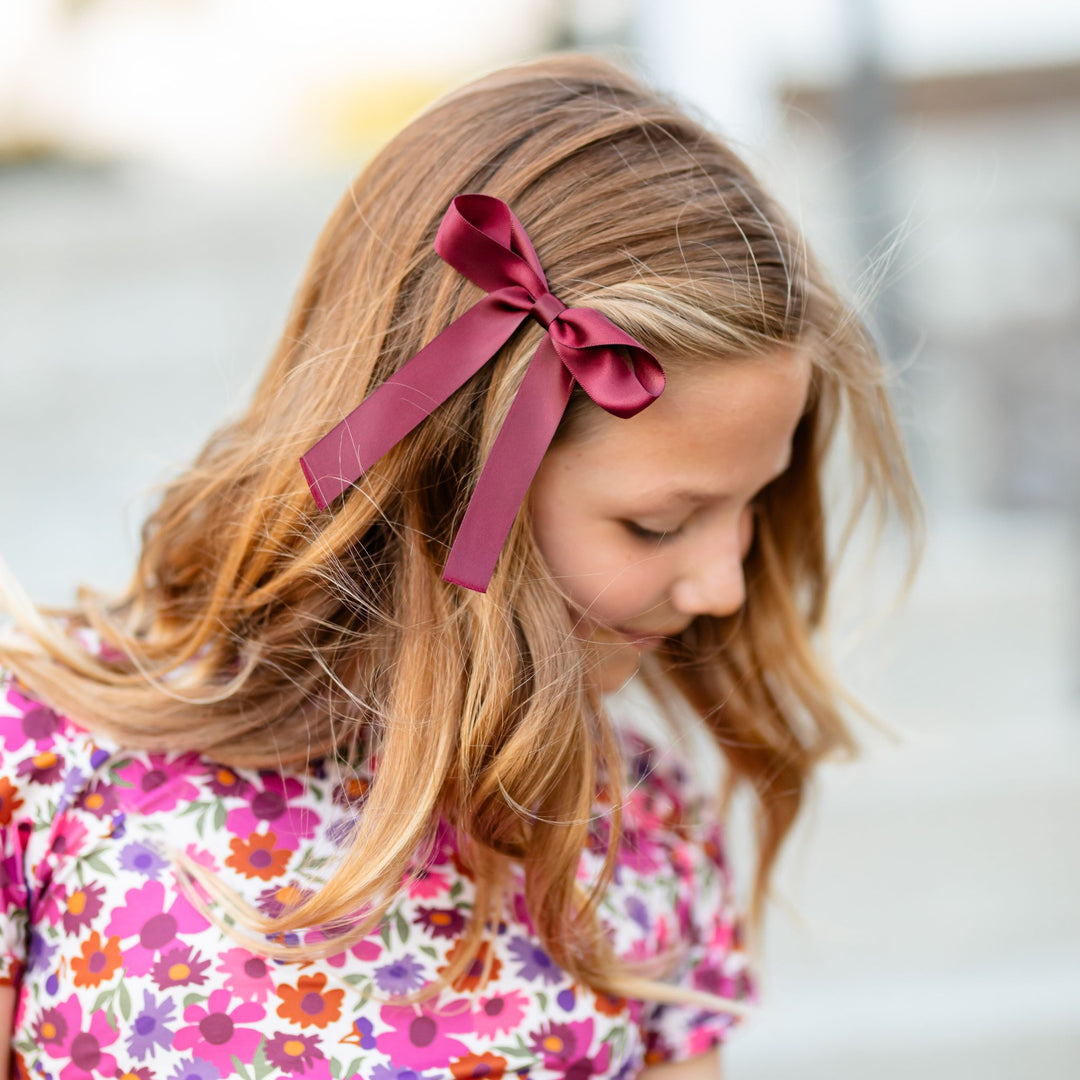 girl in burgundy satin ribbon bow on clip paired with fall floral top 