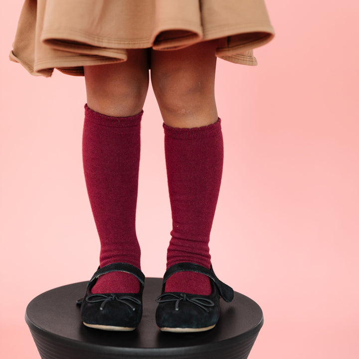 girls knit knee high socks in fall burgundy with scalloped border paired with neutral brown twirl dress