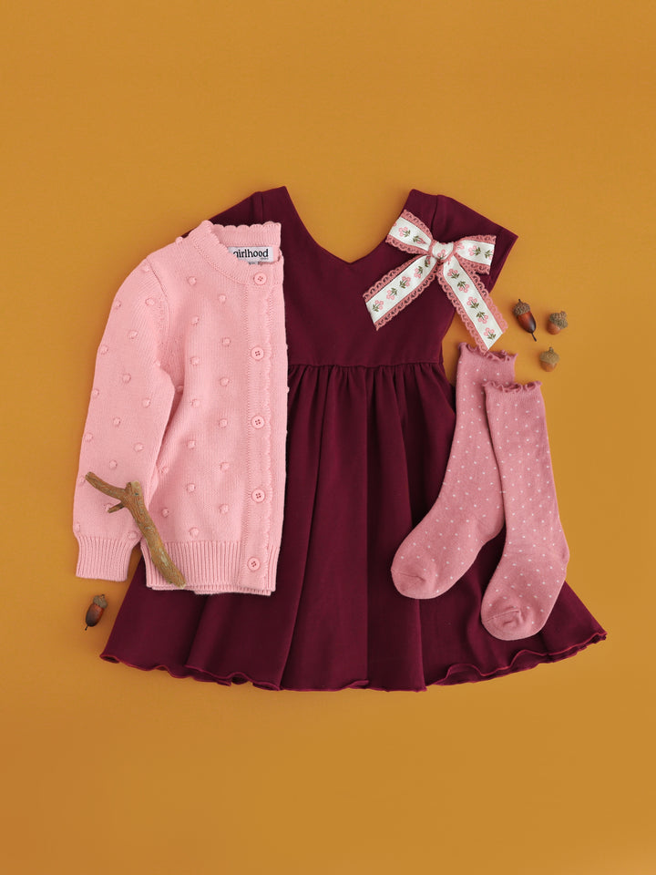 girls burgundy fall twirl dress paired with cardigan, dotted knee socks and floral bow in shades of pink for fall
