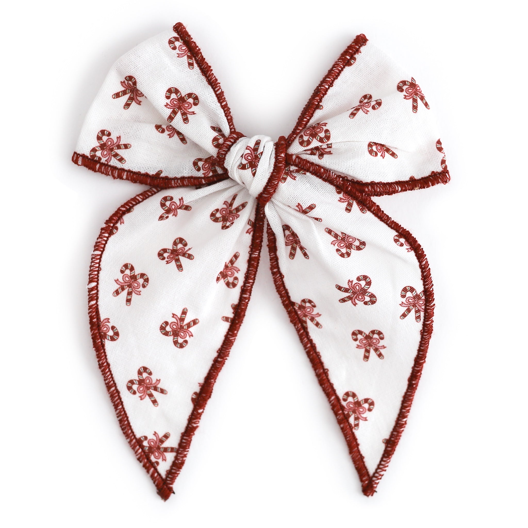 girls' white fabric bow on clip with candy cane design and red trim