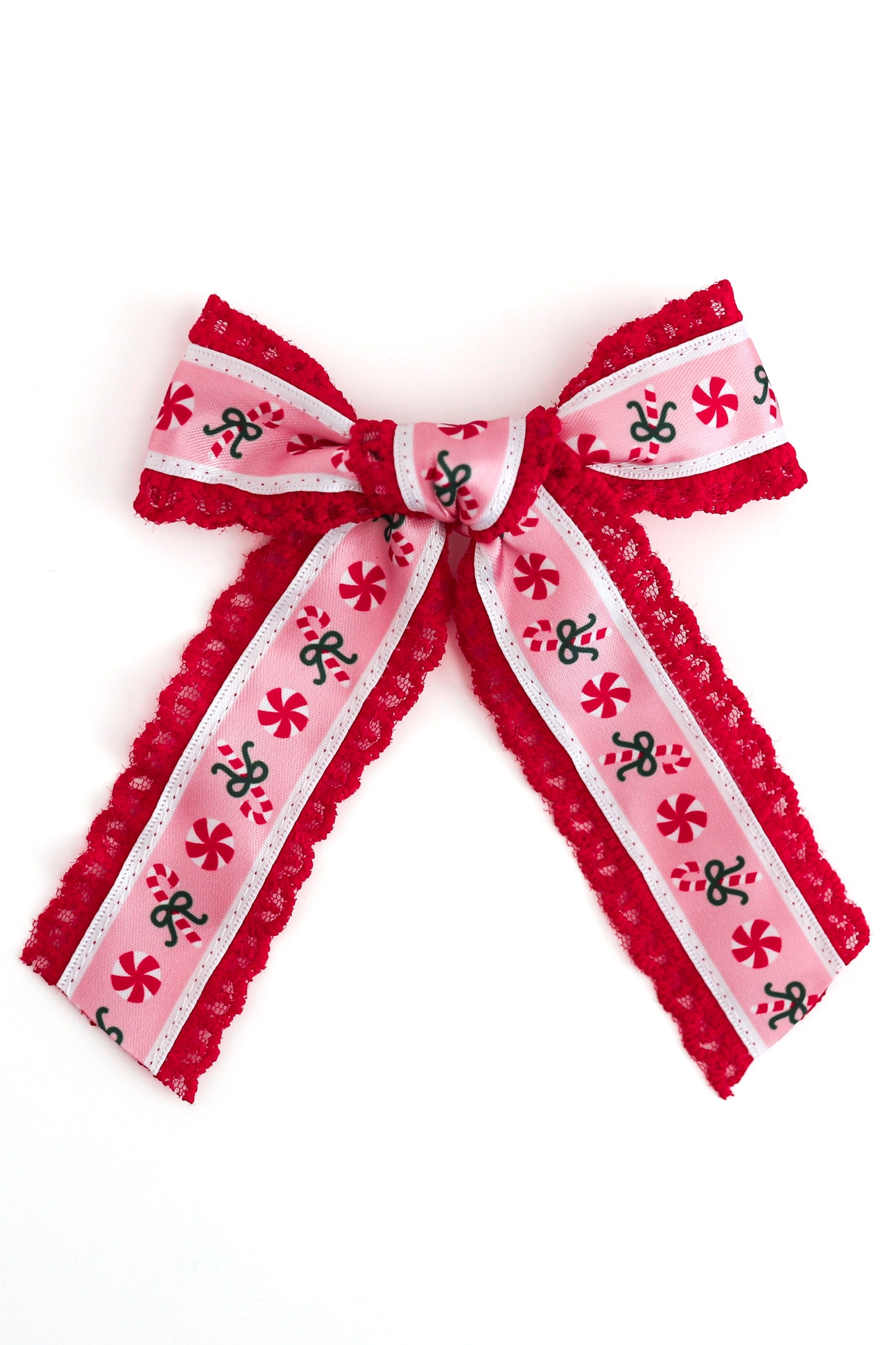 A red and pink xmas candy cane patterned ribbon bow with red lace edges, photographed on a plain white background.