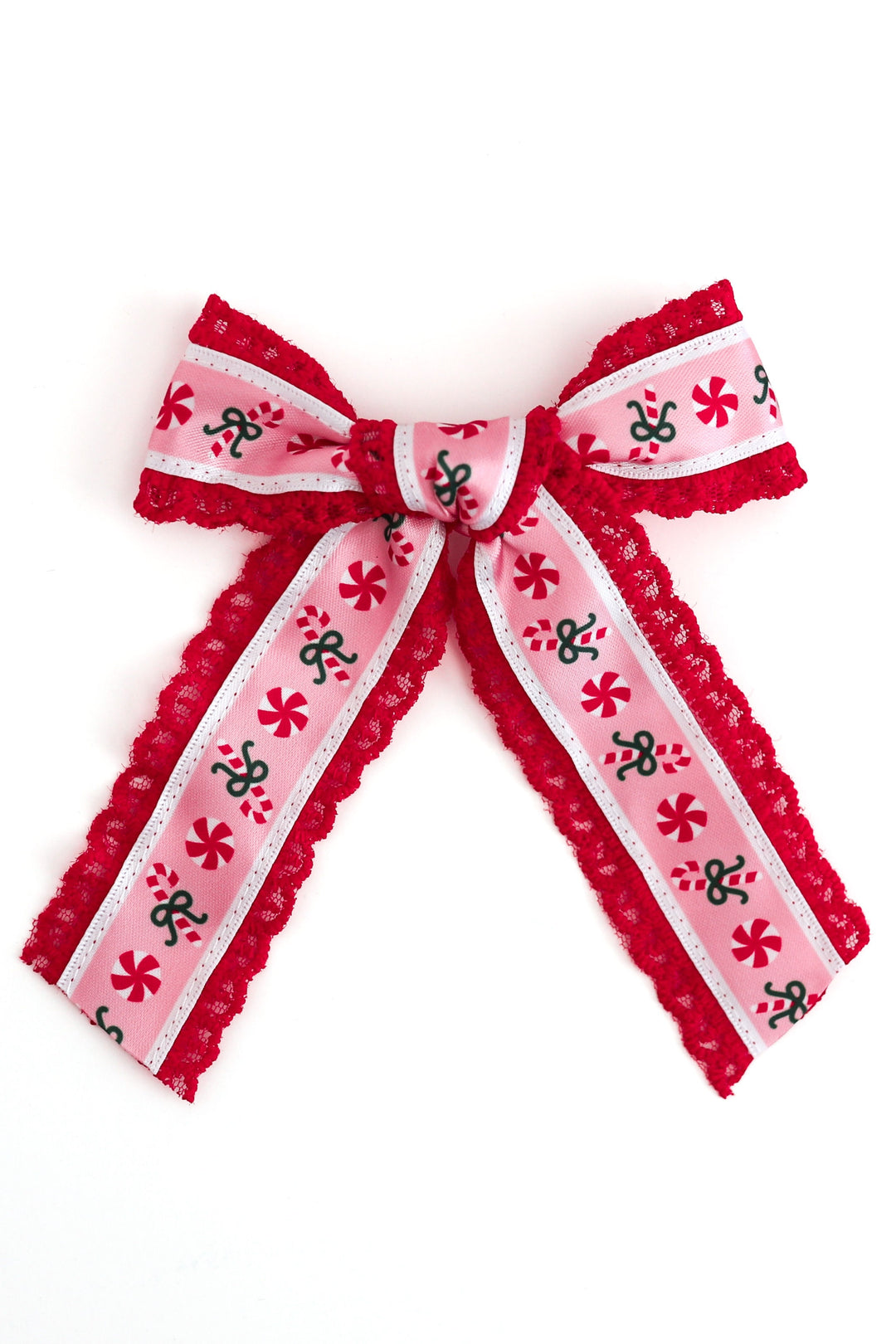 A red and pink xmas candy cane patterned ribbon bow with red lace edges, photographed on a plain white background.