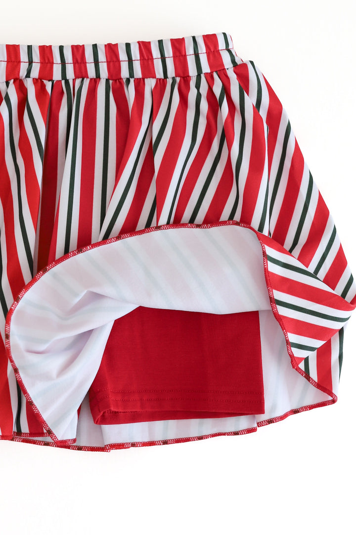 girls red, green and white striped holiday short with solid red built in shorts shown on a solid white background