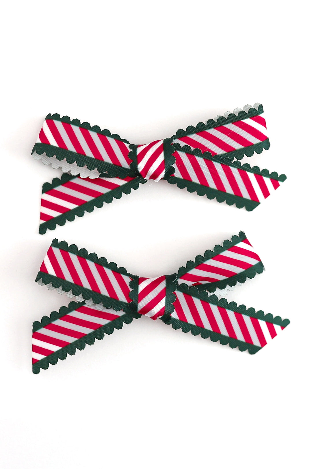 candy cane stripe ribbon pigtail bows with green scalloped edges shown on white background