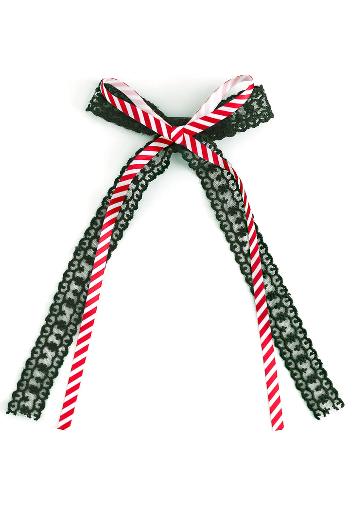 christmas hair bow with dark green lace and printed candy cane stripe ribbon on top shown on white background