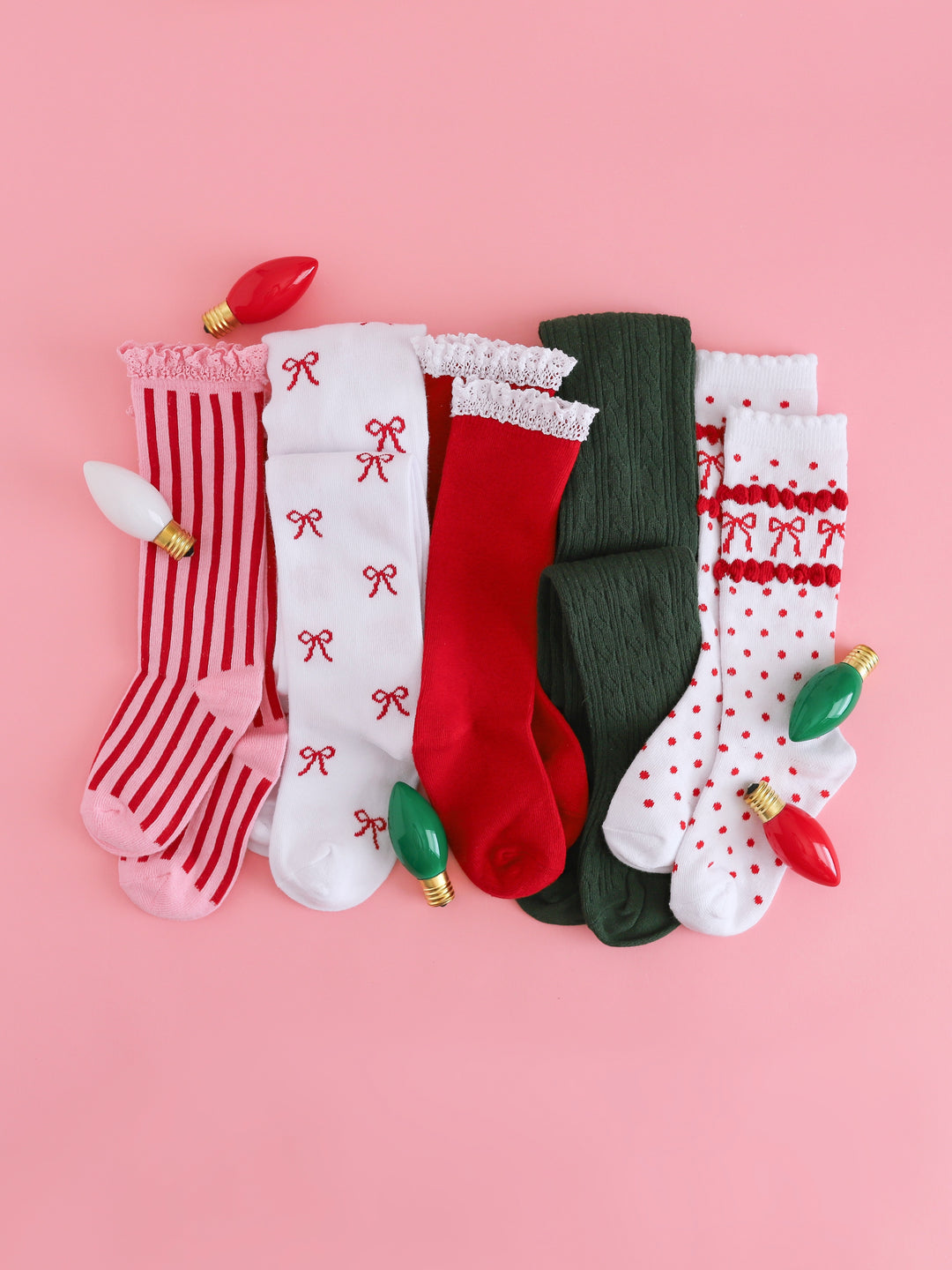 flat lay of assorted socks and knee highs to match candy cane outfits for Christmas