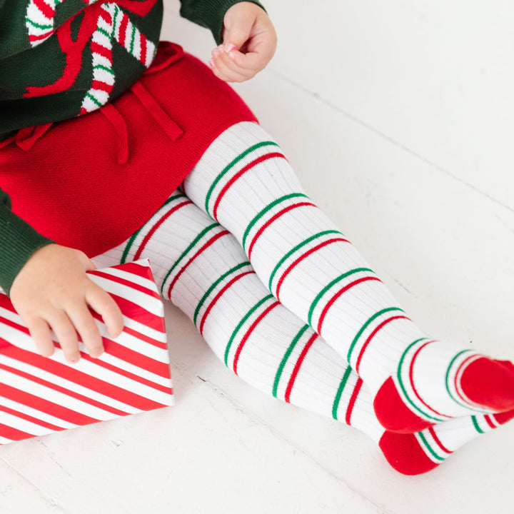 girl wearing christmas striped tights with candy cane accents