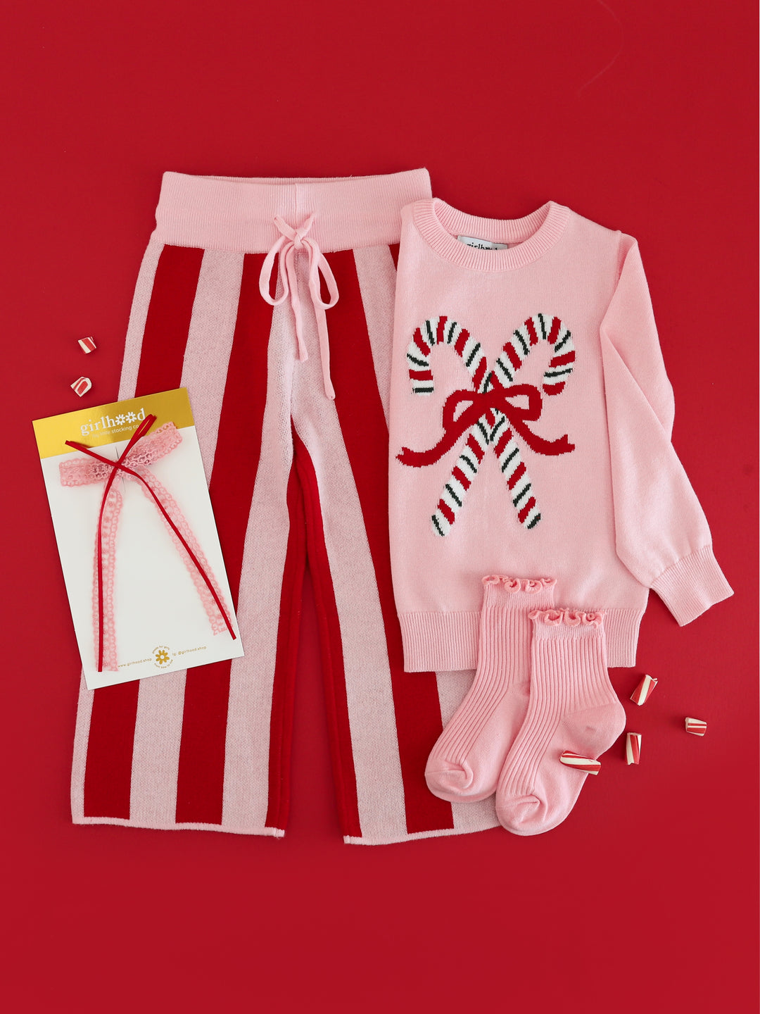pink knit sweater with vintage candy cane design paired with red and pink striped sweater pants and accessories for Christmas