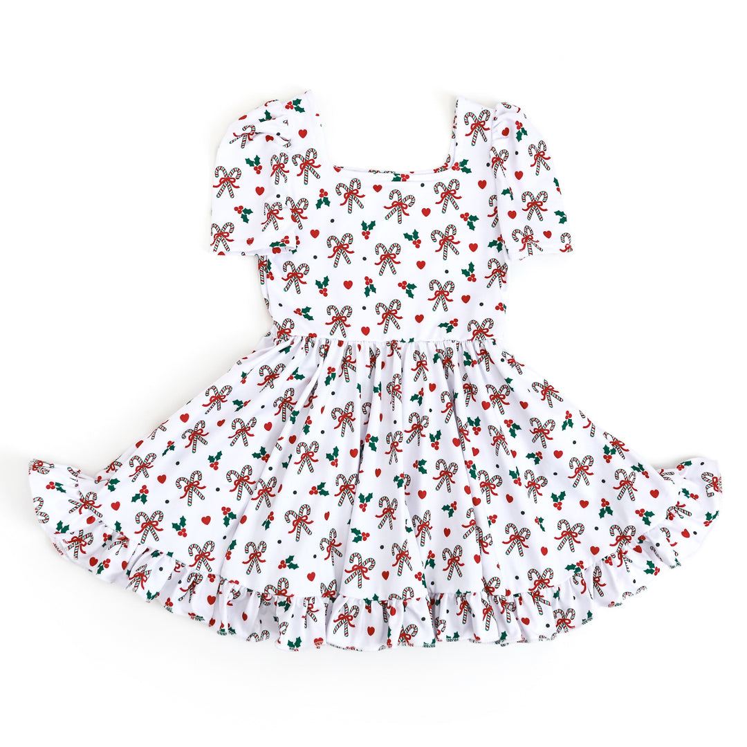 little girls classic Christmas print dress with candy cane theme and white background