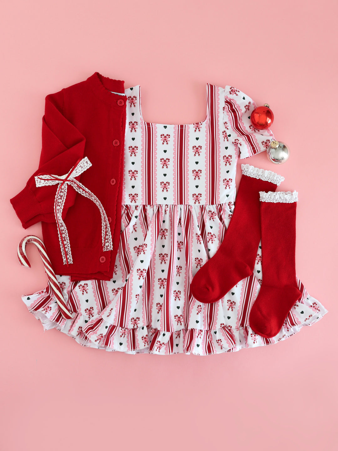 girls' candy cane inspired outfit with white, short sleeve, candy cane print twirl dress and matching red and white accessories