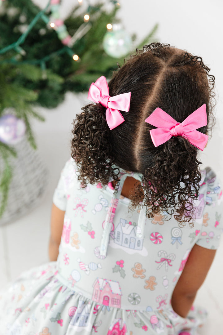 girls pink satin pigtail bows with pastel christmas dress