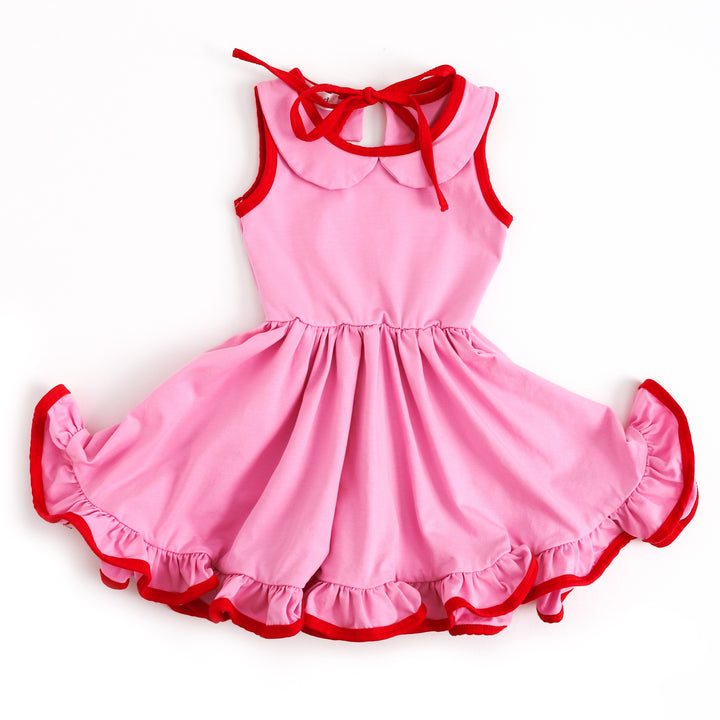 girls pink twirl dress with bright red trim