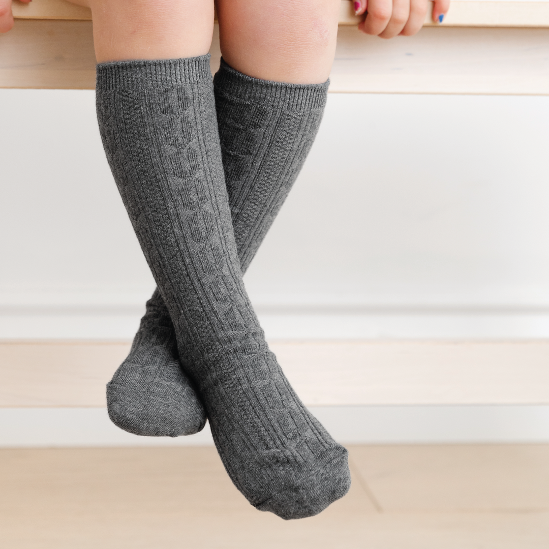 girl wearing charcoal grey cable knit knee high socks