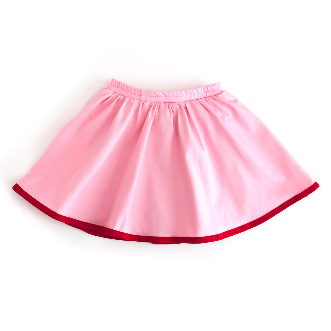 girls cotton blend pink skort with elastic waistband, red binding and matching red built in biker shorts