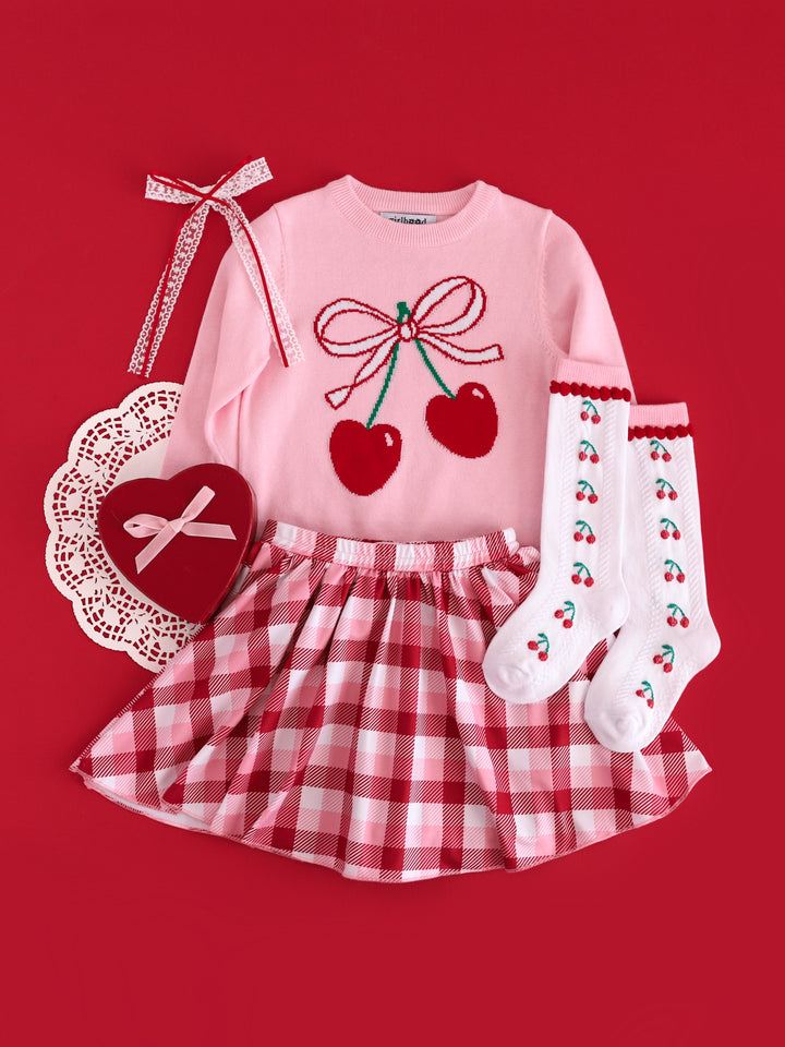 girls' pink cherry print pullover sweater paired with valentines plaid skort, cherry print knee socks and white lace with red ribbon hair bow