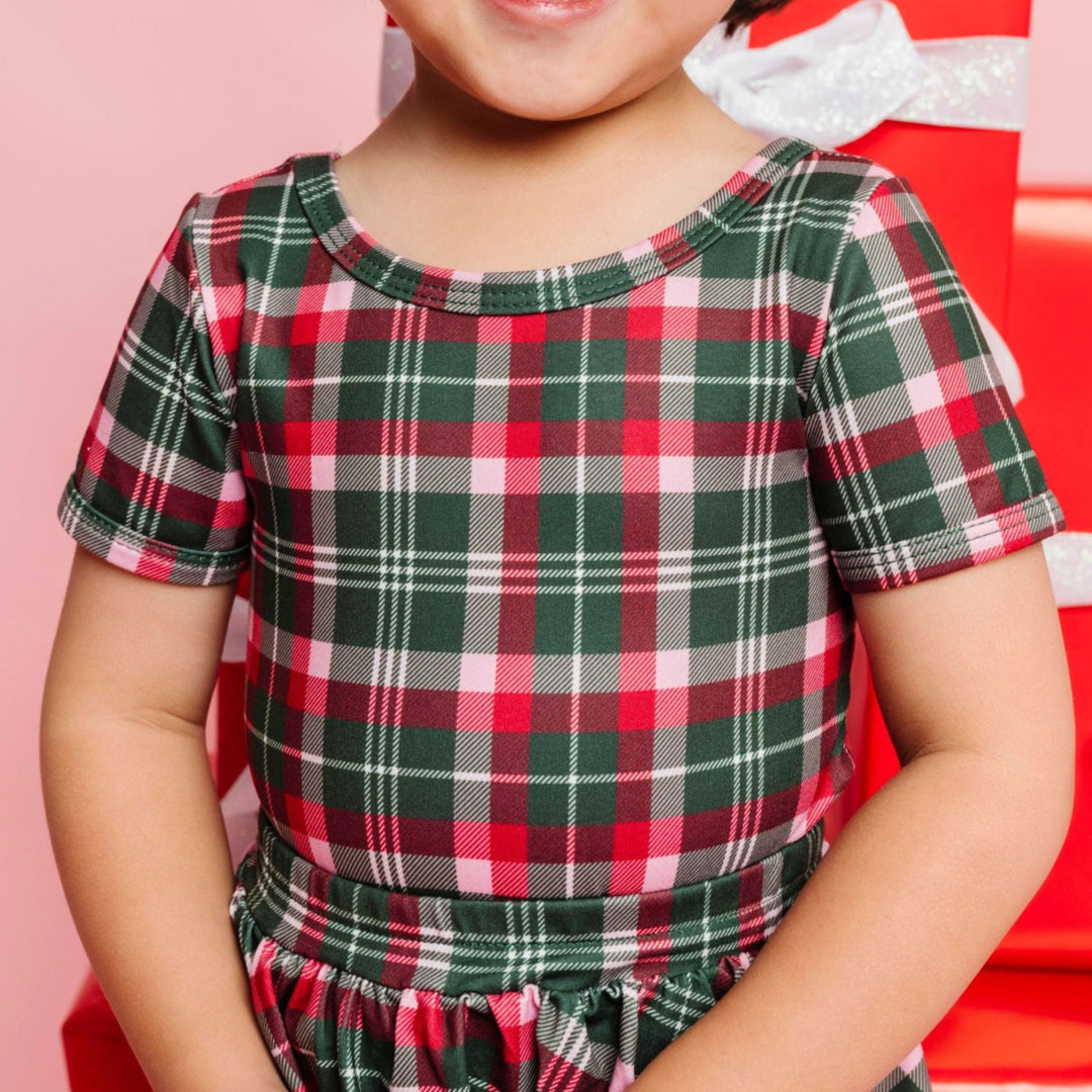 closeup of scoop neck Christmas plaid fitted top tucked into matching plaid skirt