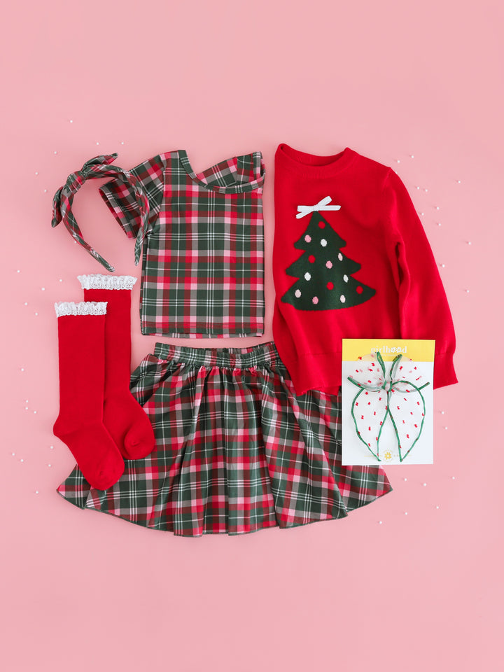girls Christmas plaid top and skirt set with red pullover knit sweater featuring Christmas tree design and matching accesories 
