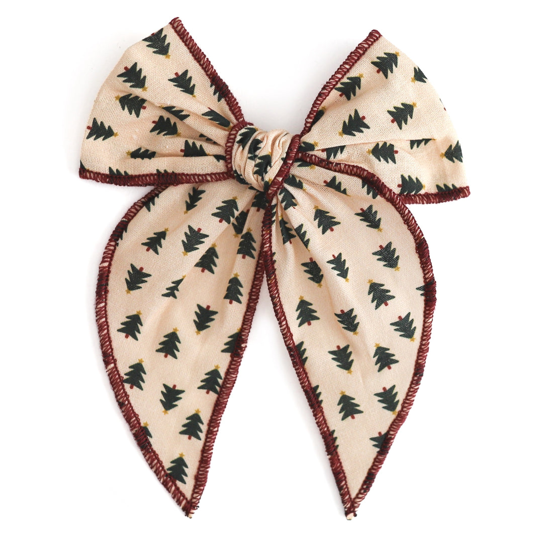 girls cream fabric bow with Christmas tree design and crimson trim