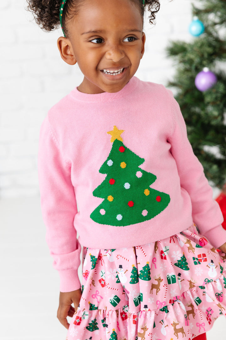 little girl in pink themed Christmas party dress and matching pullover knit sweater with tree design