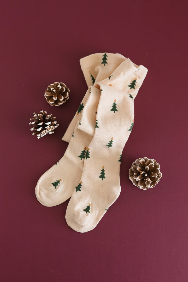 Girls cream tights featuring a festive Christmas pattern.