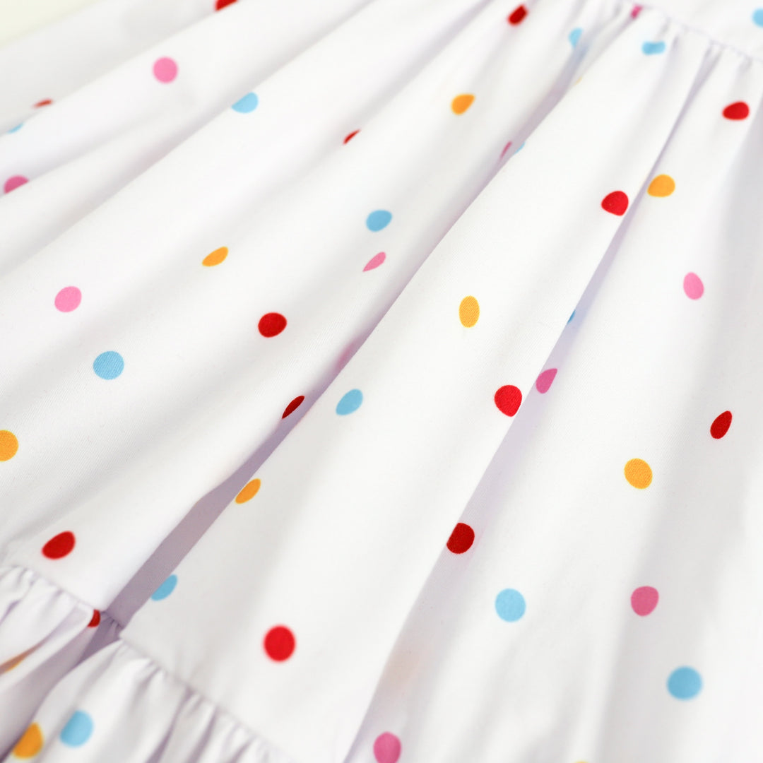 close detail of white and rainbow dot girls twirl dress