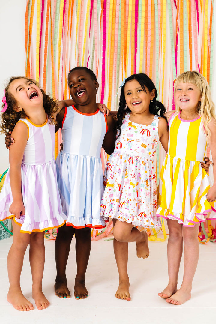 girls posing in circus print tank dress and coordinating wide striped sleeveless twirl dresses