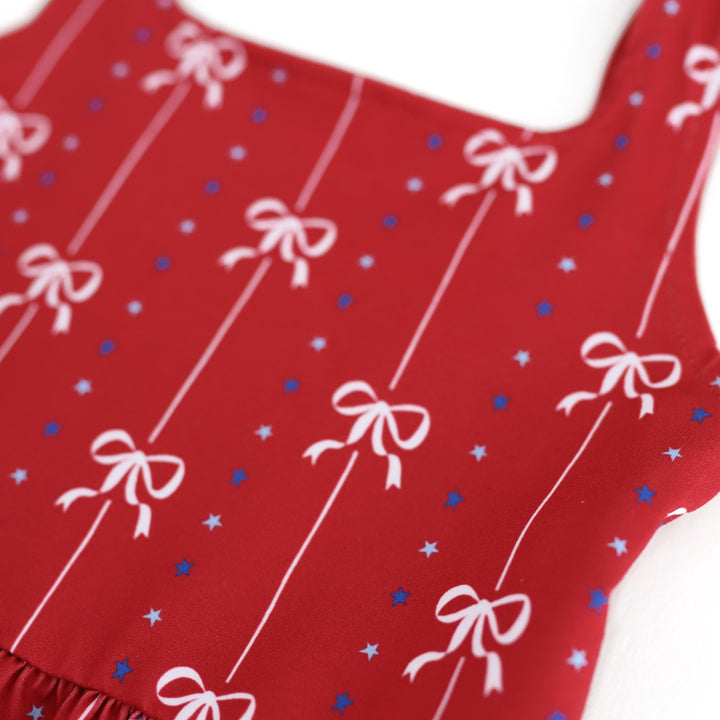 closeup of white bow and blue star print on girls' 4th of July sleeveless twirl dress