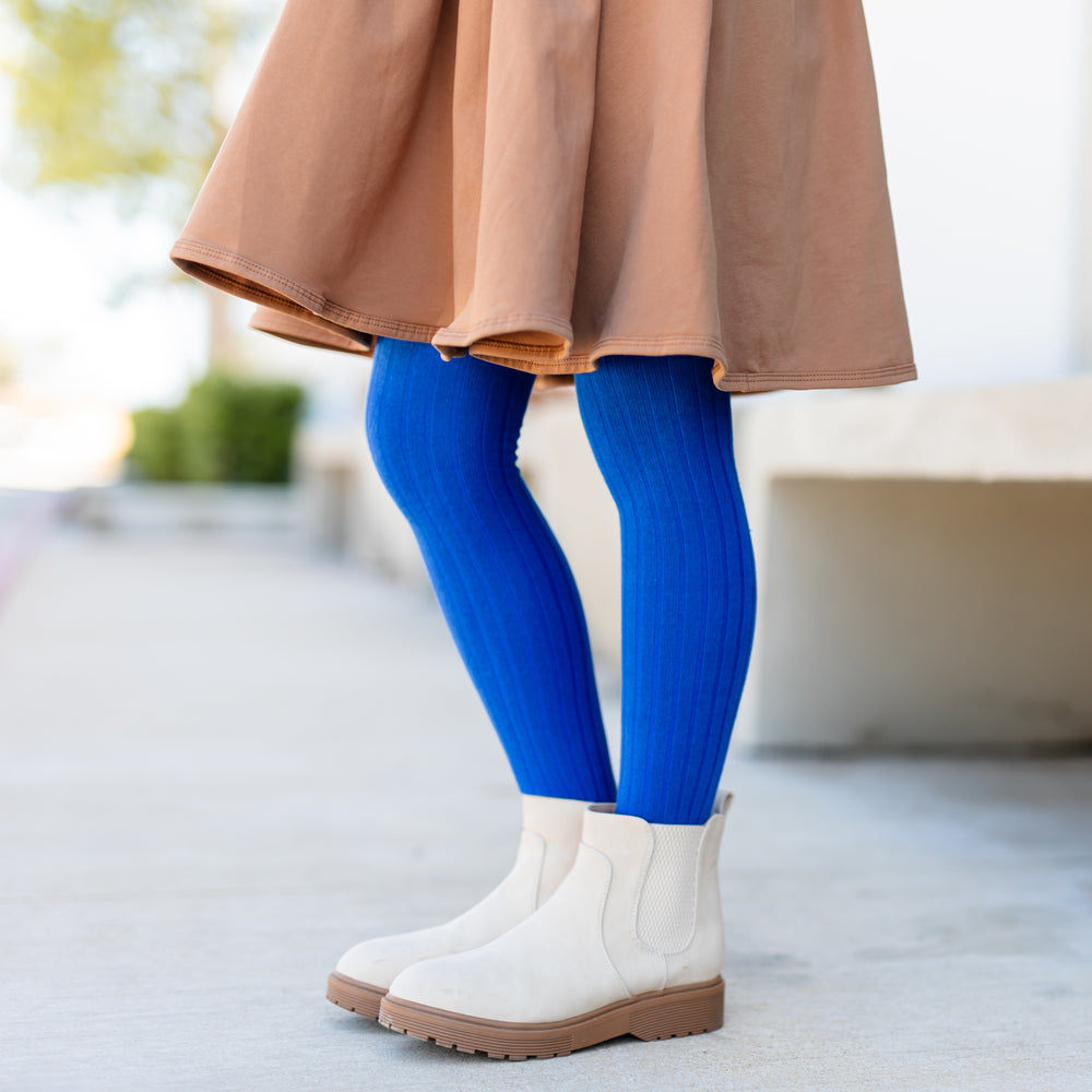 girl wearing tan mocha dress and bright blue ribbed cotton tights