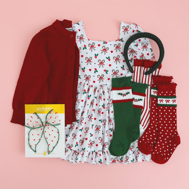 little girls candy cane print Christmas dress with matching accessories in classic Christmas colors