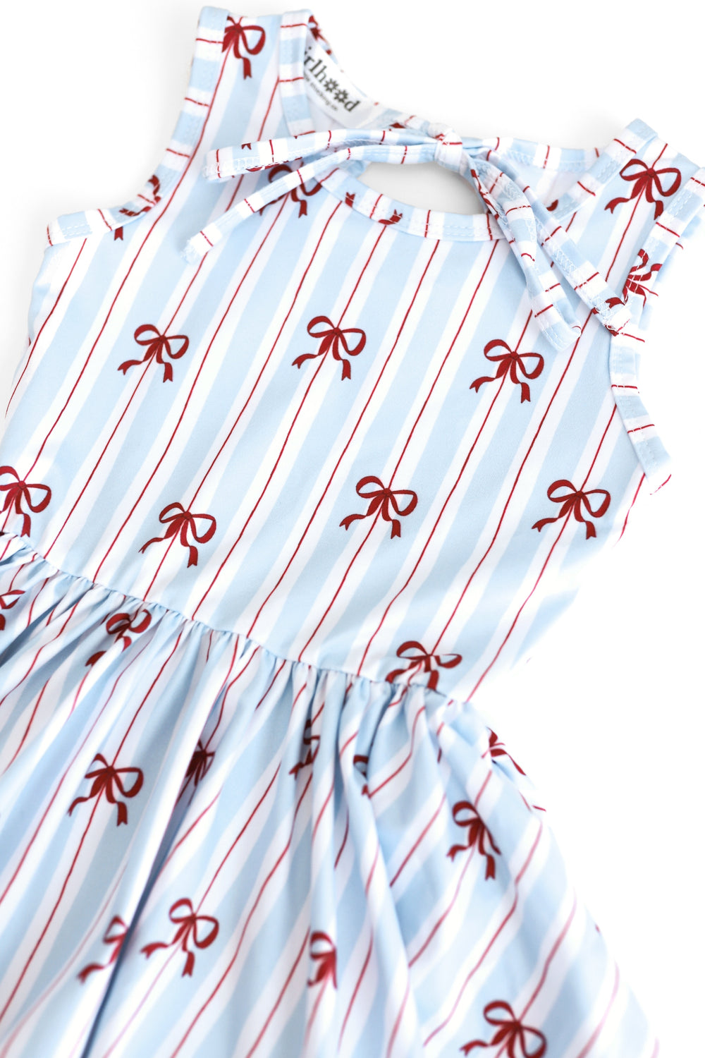 closeup photo of girls sleeveless twirl dress with white, blue and red stripe with dainty red bow print for 4th of July
