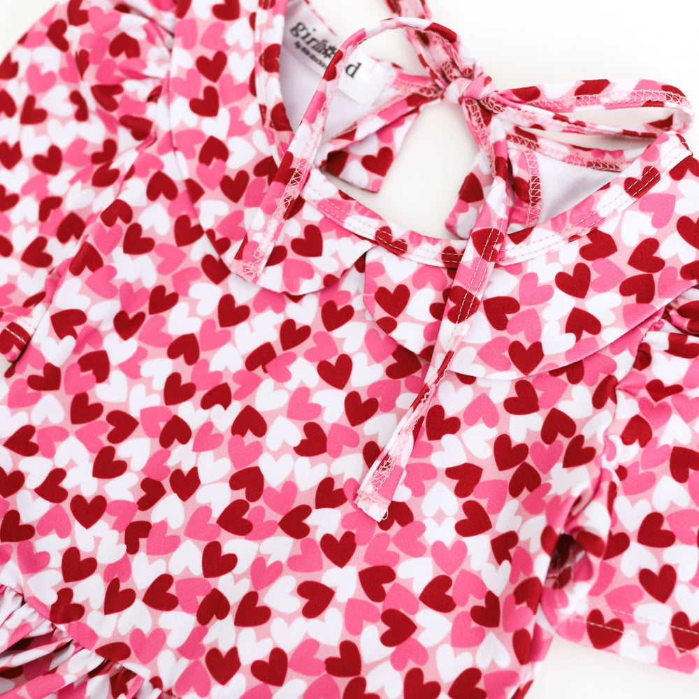 closeup photo of pink, red and white confetti heart print on collared Valentine's Day dress