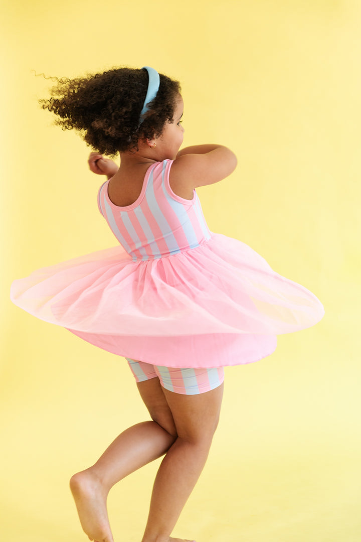 girl twirling in pink and blue cotton candy striped tutu set 