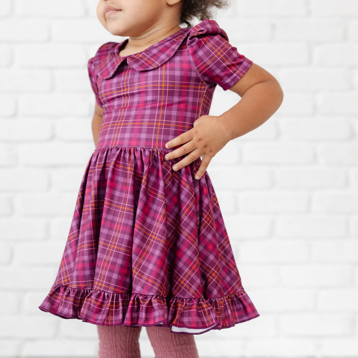 little girl standing with hands on hip in cranberry plaid twirl dress