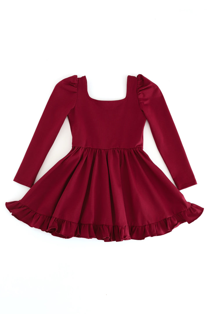 A long-sleeve burgundy dress with a square neckline, puffed shoulders, and a flared ruffled skirt, shown flat on a white background.