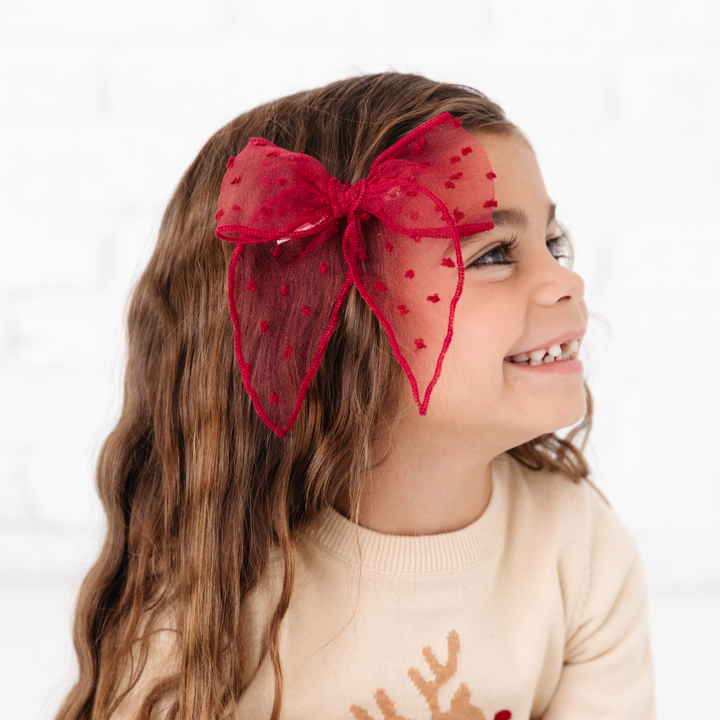 little girl wearing crimson red sheer hair bow