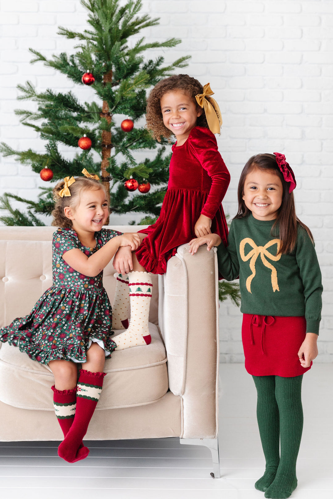 girls wearing red and green matching christmas outfits