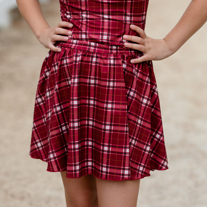 closeup of girls' crimson plaid Christmas skirt paired with matching top