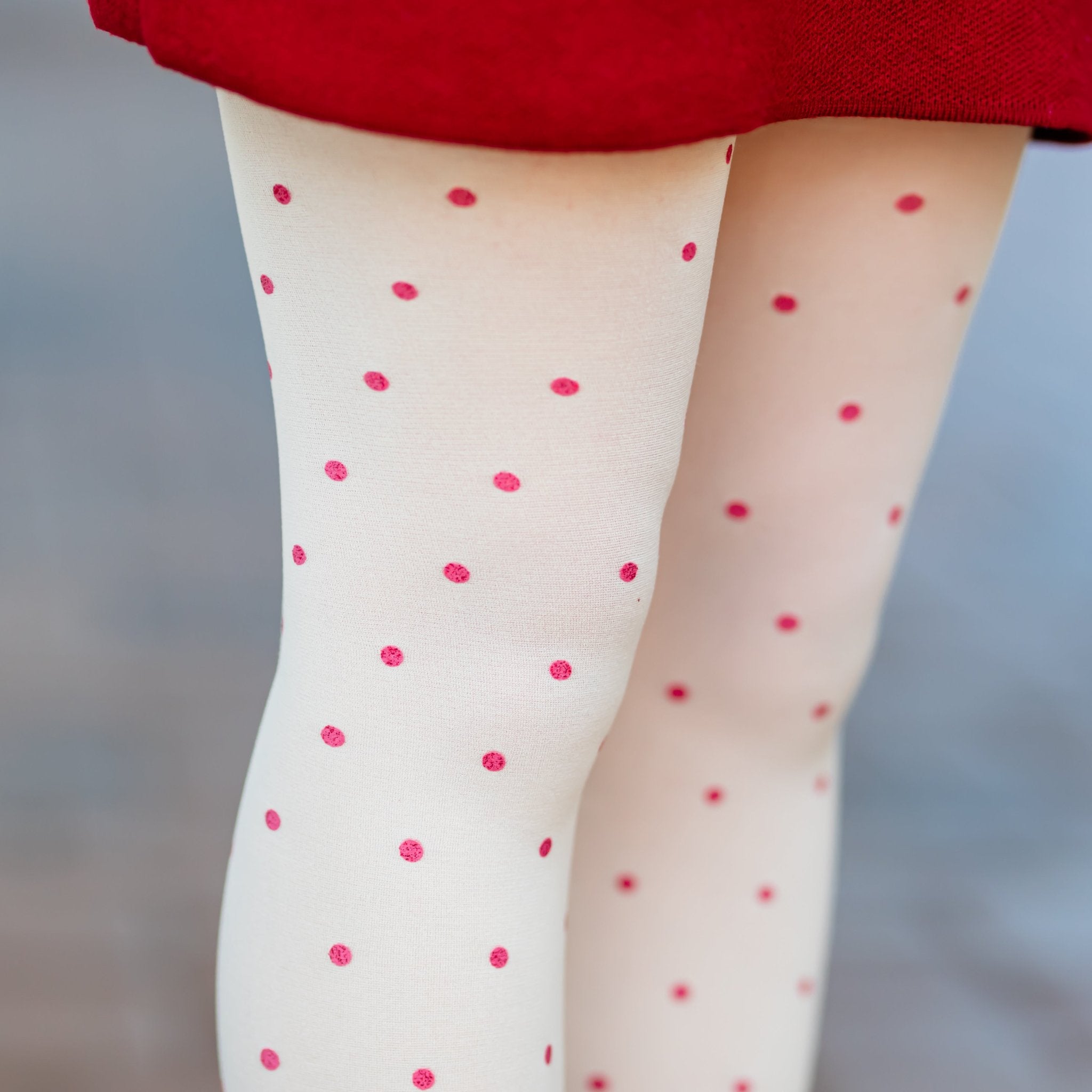 closeup of girls cream nylons with red glittery dots