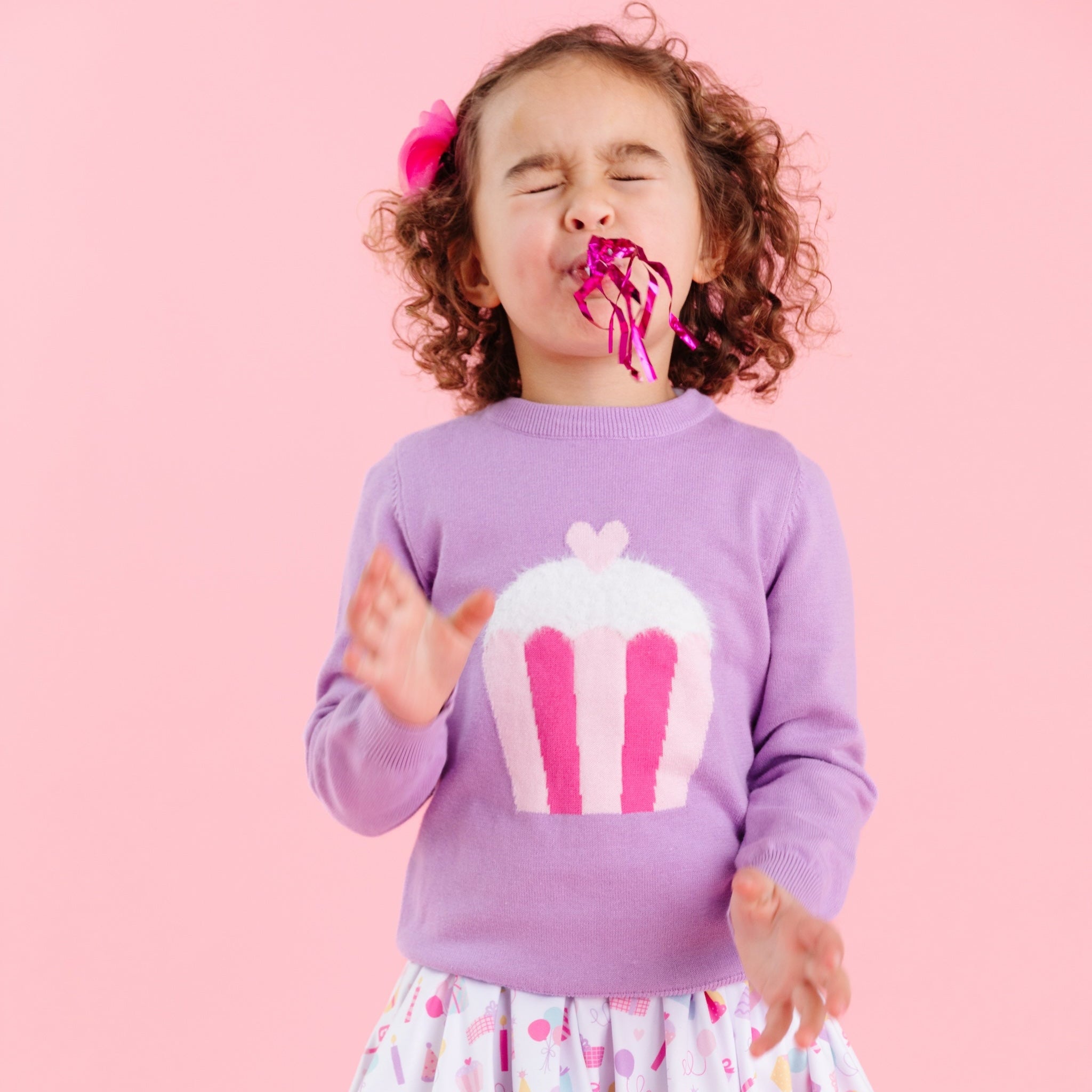 little girl in lavender cotton knit pullover sweater with pink cupcake design and birthday print dress