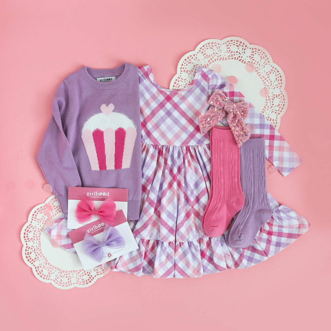 complete pink and lavender Valentine's Day inspired look with gingham long sleeve dress, cupcake sweater, and matching socks and bows for little girl