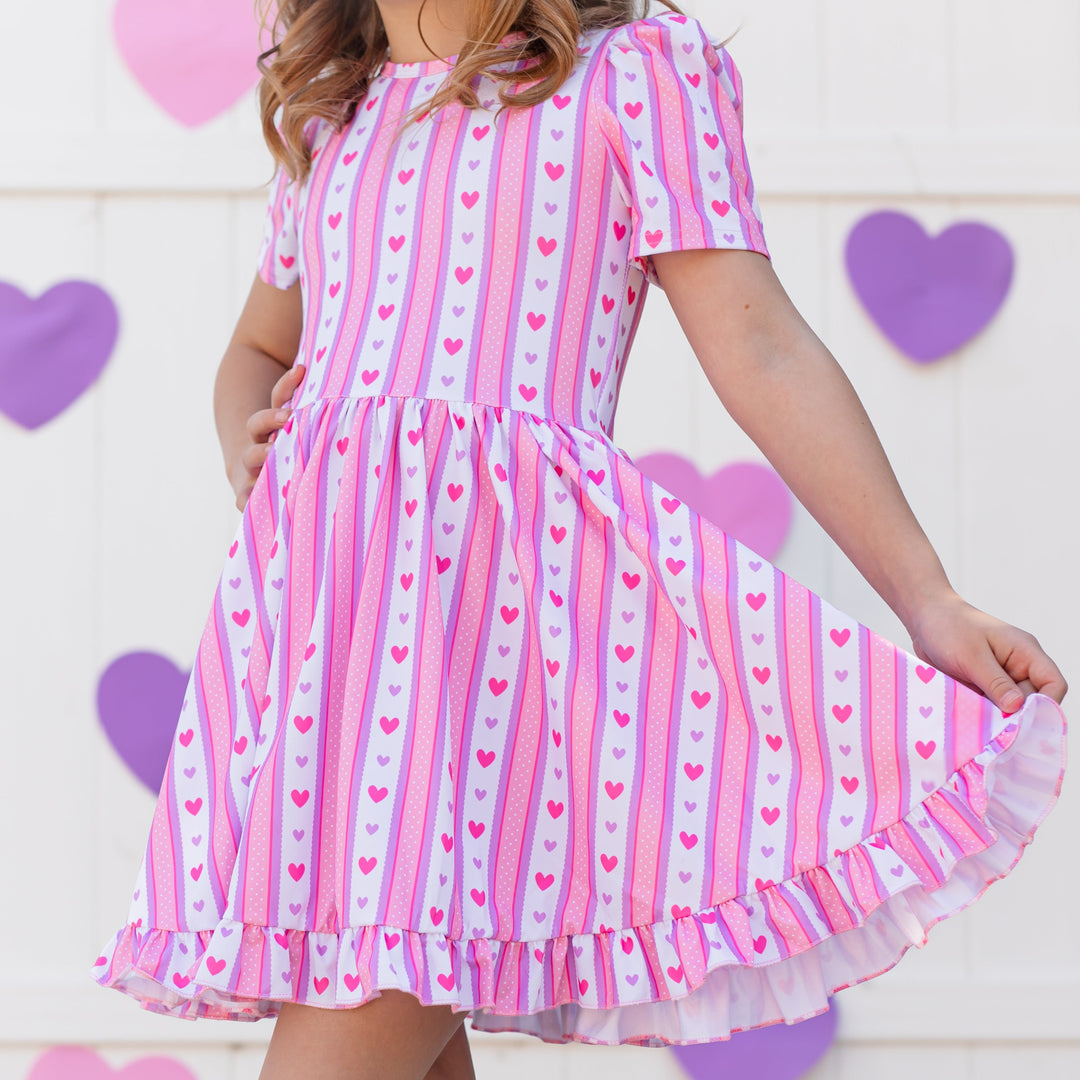 closeup of girl in pink and purple vintage wallpaper inspired Valentine's Day dress