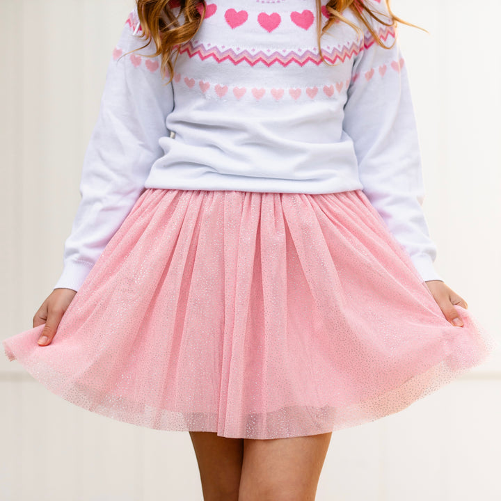 close up of light pink sparkly tulle skirt paired with white fair isle heart sweater for Valentine's Day