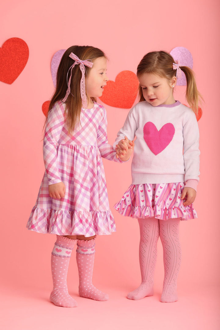 two girls in coordinating Valentine's dresses and accessories to match lavender and pink darling vibe looks