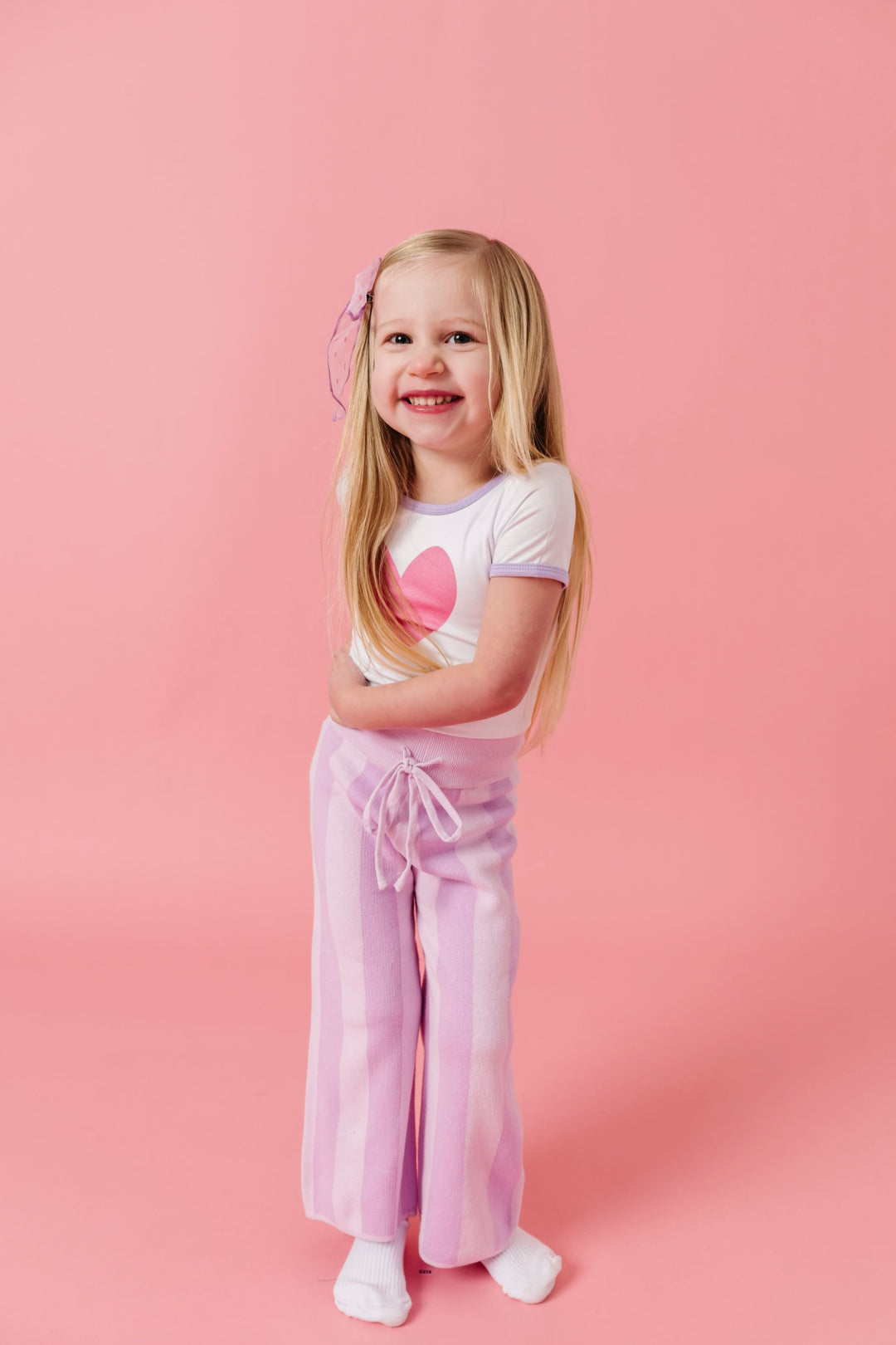 little girl in pink heart bamboo top with lavender trim paired with two tone lavender cotton knit sweater pants
