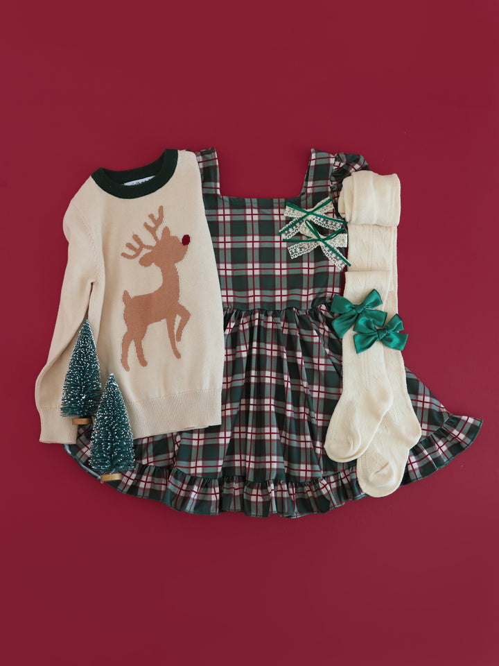 girls' cream sweater with green neckline and red nosed reindeer silhouette design paired with forest plaid twirl dress and matching cream and green accessories